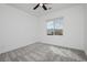 A sunny bedroom with a ceiling fan and scenic window view offering relaxing space at 7777 Vino Vranec Ct, Las Vegas, NV 89113