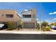 Modern two-story home featuring a neutral color palette, a two-car garage, and simple landscaping against a bright blue sky at 7777 Vino Vranec Ct, Las Vegas, NV 89113
