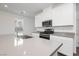 Modern kitchen with stainless steel appliances and a large quartz countertop island at 7777 Vino Vranec Ct, Las Vegas, NV 89113