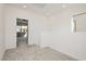 Cozy loft area with plush gray carpet and access to a balcony at 7777 Vino Vranec Ct, Las Vegas, NV 89113