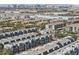 Wide aerial view of a planned residential community with modern townhomes and city skyline in the distance at 8042 Misty Canyon Ave, Las Vegas, NV 89113