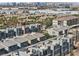 Scenic aerial view of the community showcasing modern home architecture and distant city skyline at 8042 Misty Canyon Ave, Las Vegas, NV 89113