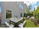 Cozy backyard with a dining set, lounge seating, and lush artificial turf, perfect for outdoor entertaining at 8042 Misty Canyon Ave, Las Vegas, NV 89113