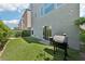 Backyard features a green lawn and a grill, perfect for outdoor barbecues and entertaining at 8042 Misty Canyon Ave, Las Vegas, NV 89113