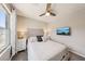 Bright bedroom featuring a queen bed, ceiling fan, and mounted television at 8042 Misty Canyon Ave, Las Vegas, NV 89113
