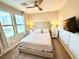 Bright bedroom with neutral tones, large windows, and a ceiling fan at 8042 Misty Canyon Ave, Las Vegas, NV 89113