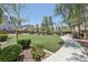 Well-maintained community park with lush grass, mature trees, and walking path at 8042 Misty Canyon Ave, Las Vegas, NV 89113