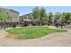Enclosed community dog park with shaded seating area, mature trees, and a green space at 8042 Misty Canyon Ave, Las Vegas, NV 89113