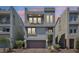 Modern three-story home featuring stucco, balconies, garage, and low-maintenance landscaping at 8042 Misty Canyon Ave, Las Vegas, NV 89113