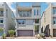 Contemporary three-story home featuring a balcony and two-car garage in an up-scale community at 8042 Misty Canyon Ave, Las Vegas, NV 89113