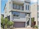 Contemporary three-story home featuring a balcony and two-car garage in an up-scale community at 8042 Misty Canyon Ave, Las Vegas, NV 89113