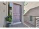 Stylish front door with modern hardware, next to a window and decorative potted plant at 8042 Misty Canyon Ave, Las Vegas, NV 89113