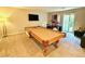 Open game room with a pool table, drums, television, and sliding doors at 8042 Misty Canyon Ave, Las Vegas, NV 89113