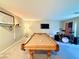 Spacious game room features a pool table, drum set and mounted television at 8042 Misty Canyon Ave, Las Vegas, NV 89113
