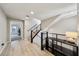 Bright hallway with wood floors, modern staircase, and a view into another room at 8042 Misty Canyon Ave, Las Vegas, NV 89113