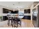 Modern kitchen boasts a large island with seating, stainless steel appliances, and stylish dark cabinets at 8042 Misty Canyon Ave, Las Vegas, NV 89113