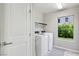 Functional laundry room with modern washer and dryer, plus a window that offers natural light at 8042 Misty Canyon Ave, Las Vegas, NV 89113