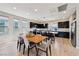 Open-concept living space with dining and kitchen area with an island and modern decor at 8042 Misty Canyon Ave, Las Vegas, NV 89113