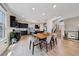 Open-concept living space with dining area and kitchen, featuring modern decor and natural light at 8042 Misty Canyon Ave, Las Vegas, NV 89113