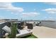 Rooftop deck features a modern outdoor dining set, lounge seating and turf, perfect for entertaining at 8042 Misty Canyon Ave, Las Vegas, NV 89113