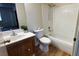 This bathroom features wood-look vinyl floors, a shower and tub combination, and a tiled backsplash at 8410 Eldora Ave # 2046, Las Vegas, NV 89117