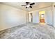 Spacious bedroom features soft carpet, a ceiling fan, and a doorway leading to the ensuite bathroom at 8410 Eldora Ave # 2046, Las Vegas, NV 89117