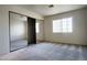 Cozy bedroom featuring mirrored closet doors, plush gray carpet, and a bright window at 8410 Eldora Ave # 2046, Las Vegas, NV 89117