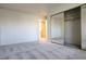 Bright bedroom featuring plush gray carpeting, mirrored closet doors, and neutral wall paint at 8410 Eldora Ave # 2046, Las Vegas, NV 89117