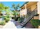 A charming exterior shot shows a landscaped walkway leading to a second-story unit at 8410 Eldora Ave # 2046, Las Vegas, NV 89117