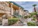 Exterior of a multi-story condo building with stairs and landscaping, creating a welcoming entrance at 8410 Eldora Ave # 2046, Las Vegas, NV 89117