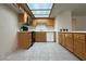 Cozy kitchen featuring light-colored cabinets, essential appliances, and a skylight overhead at 8410 Eldora Ave # 2046, Las Vegas, NV 89117