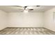 Spacious living room with a ceiling fan and neutral carpeting throughout the home at 8410 Eldora Ave # 2046, Las Vegas, NV 89117