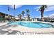 Enjoy a community pool surrounded by lush palm trees and well-maintained landscaping at 8410 Eldora Ave # 2046, Las Vegas, NV 89117