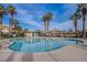 A community pool surrounded by lush palm trees under a clear, sunny sky, perfect for relaxation at 8410 Eldora Ave # 2046, Las Vegas, NV 89117