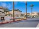 The exterior view shows well-maintained street with building, trees and landscaping at 8410 Eldora Ave # 2046, Las Vegas, NV 89117