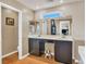 Bathroom with double vanity, dark wood cabinetry, large mirror, and window at 8754 Brindisi Park Ave, Las Vegas, NV 89148