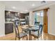 Modern dining room with dark wood cabinets, stainless steel appliances, and sliding glass door access at 8754 Brindisi Park Ave, Las Vegas, NV 89148