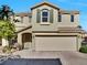 Two-story home featuring a large, attached two-car garage and desert-friendly landscaping at 8754 Brindisi Park Ave, Las Vegas, NV 89148