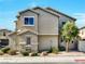 The side view of a two-story home featuring desert-friendly landscaping and a shingle roof at 8754 Brindisi Park Ave, Las Vegas, NV 89148