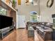 Open living room featuring a vaulted ceiling, a ceiling fan and a large, comfortable leather sofa at 8754 Brindisi Park Ave, Las Vegas, NV 89148