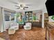 Cozy and well-lit living room featuring an inviting sitting area and a decorative ceiling fan at 8754 Brindisi Park Ave, Las Vegas, NV 89148