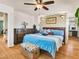 Spacious main bedroom with hardwood floors, ceiling fan, dresser and comfortable bed at 8754 Brindisi Park Ave, Las Vegas, NV 89148