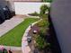Lush backyard featuring a manicured lawn, garden, and landscape lighting at 9705 Templemore Ave # 102, Las Vegas, NV 89129