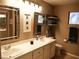 Bright bathroom featuring double sinks, ample counter space, and modern fixtures at 9705 Templemore Ave # 102, Las Vegas, NV 89129