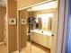 Bathroom with a walk-in shower and vanity with double sinks, storage and a large mirror at 9705 Templemore Ave # 102, Las Vegas, NV 89129