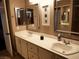 Bright bathroom featuring a double sink vanity, framed mirrors, and decorative wall art at 9705 Templemore Ave # 102, Las Vegas, NV 89129