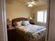 Comfortable bedroom featuring a patterned bedspread and shuttered window at 9705 Templemore Ave # 102, Las Vegas, NV 89129