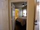 View into a cozy bedroom with hardwood floors, ensuite bathroom, and ceiling fan at 9705 Templemore Ave # 102, Las Vegas, NV 89129