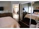 Spacious bedroom with mirrored closet doors reflecting the room and connecting to the living area at 9705 Templemore Ave # 102, Las Vegas, NV 89129