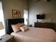 Inviting bedroom showcasing a queen-sized bed, dresser, and windows with coverings at 9705 Templemore Ave # 102, Las Vegas, NV 89129